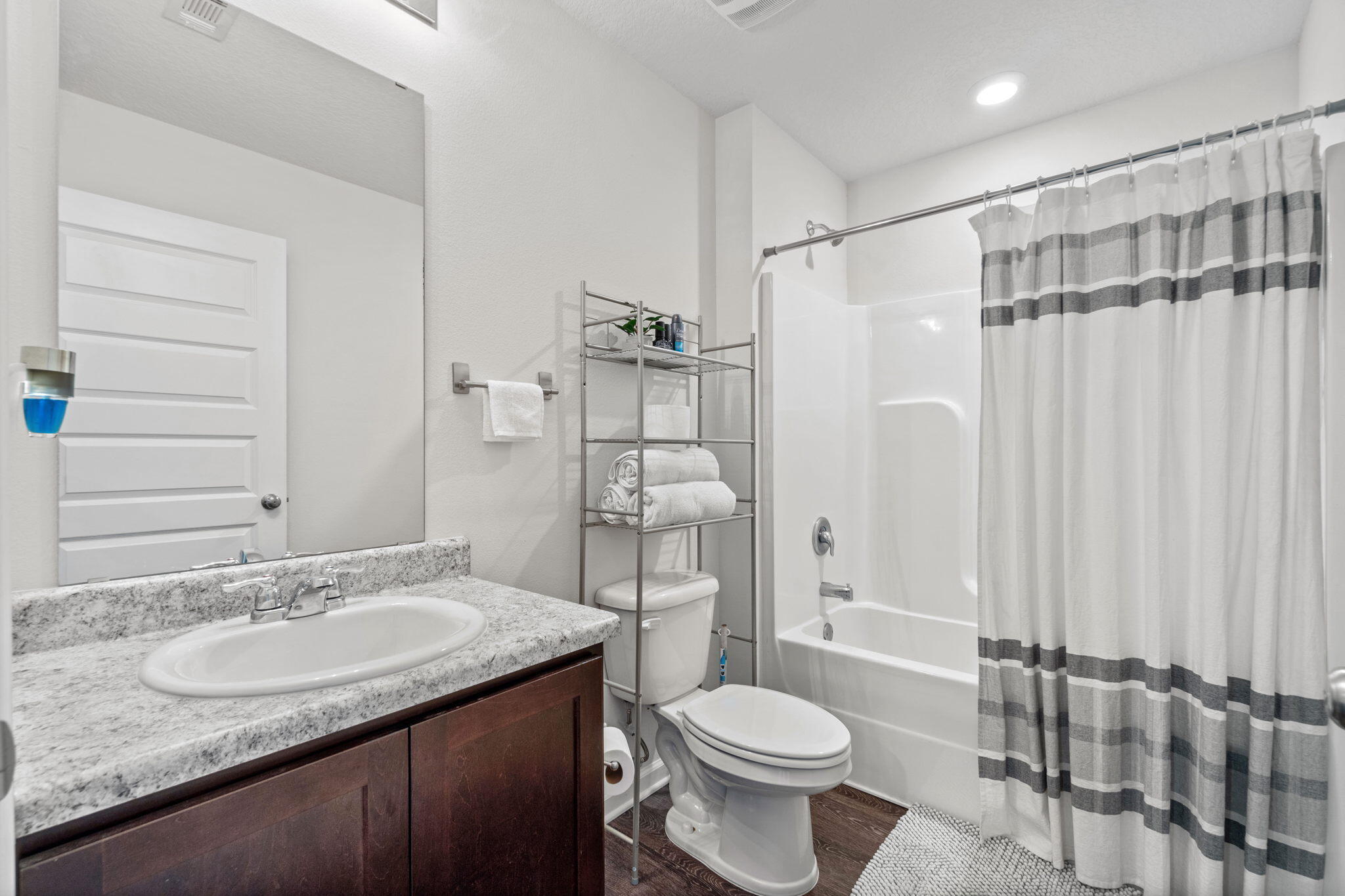 209 Laurel Hill Street Crestview, FL 32539 - Photo 24 of 43 a bathroom with a granite countertop sink toilet and shower