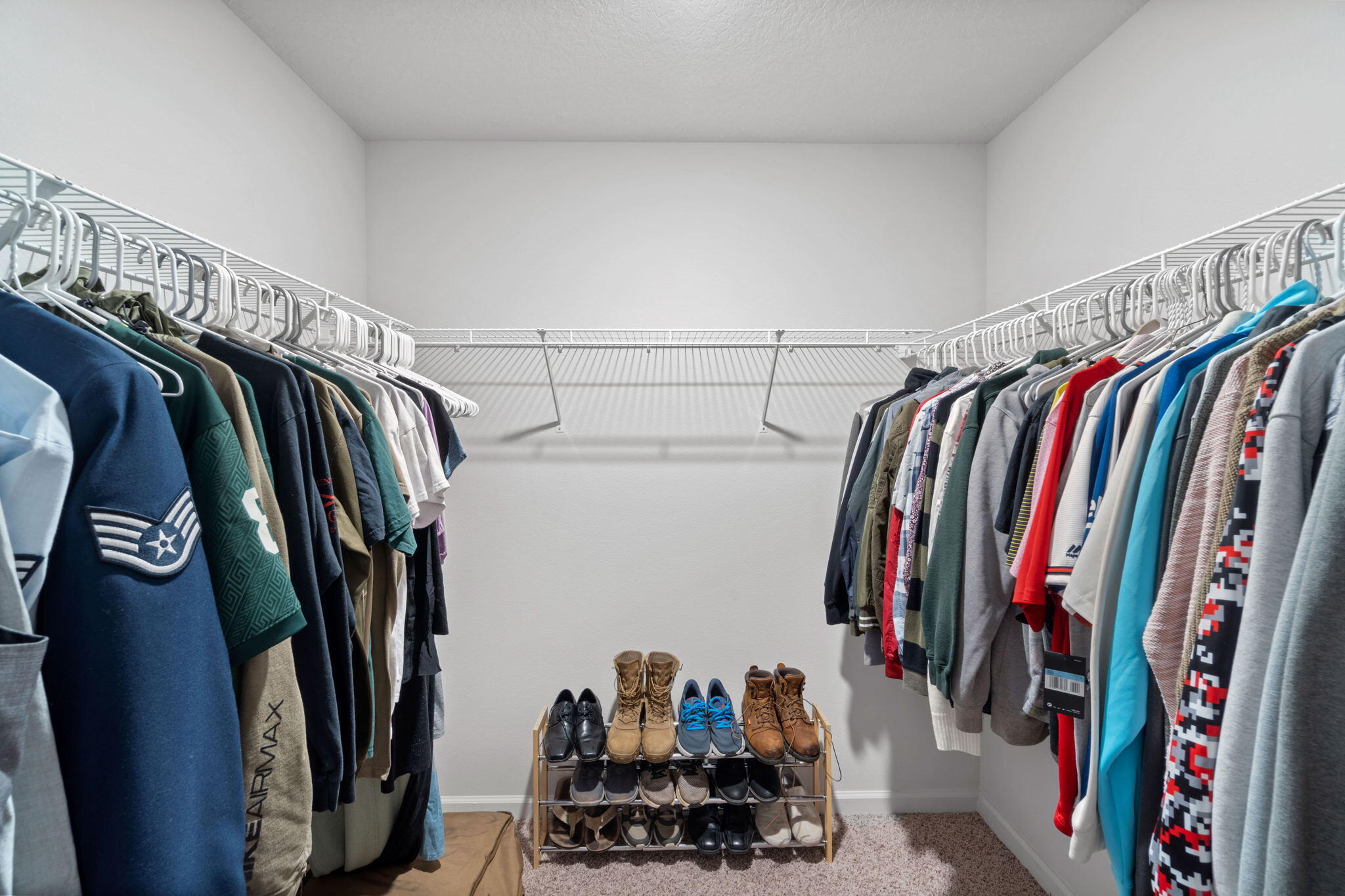 209 Laurel Hill Street Crestview, FL 32539 - Photo 36 of 43 a view of walk in closet with clothes and shoes