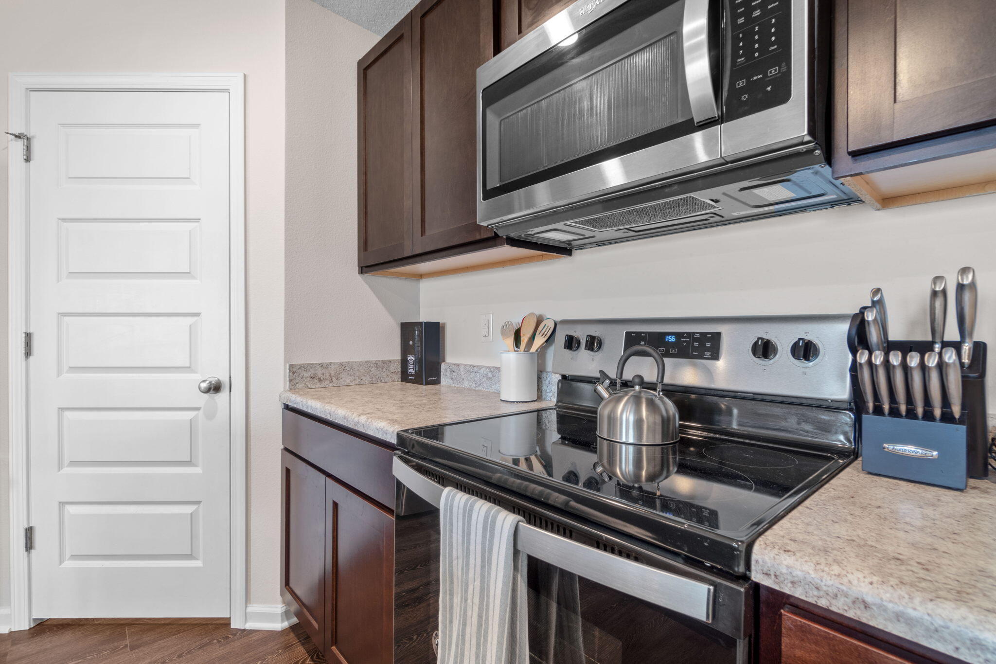 209 Laurel Hill Street Crestview, FL 32539 - Photo 10 of 43 a kitchen with stainless steel appliances granite countertop a stove and a microwave