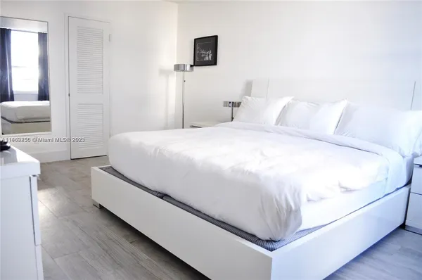 a spacious bedroom with a bed and a couch