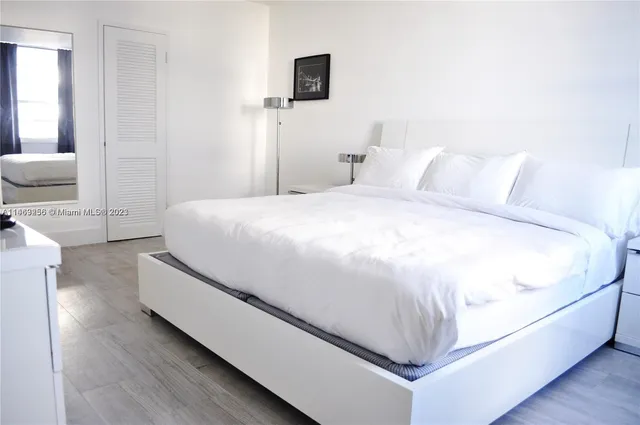 a spacious bedroom with a bed and a couch