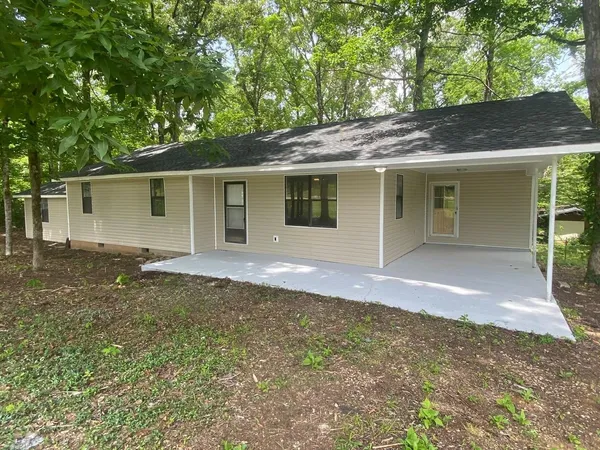 a front view of house with yard and trees