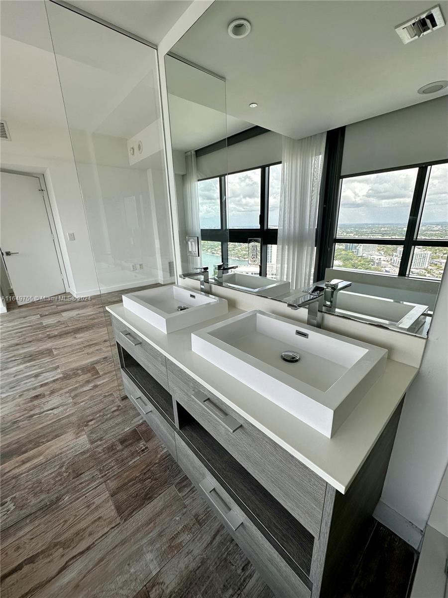 Edgewater Miami, FL 33137 - Photo 11 of 13 a bathroom with a sink and a large window