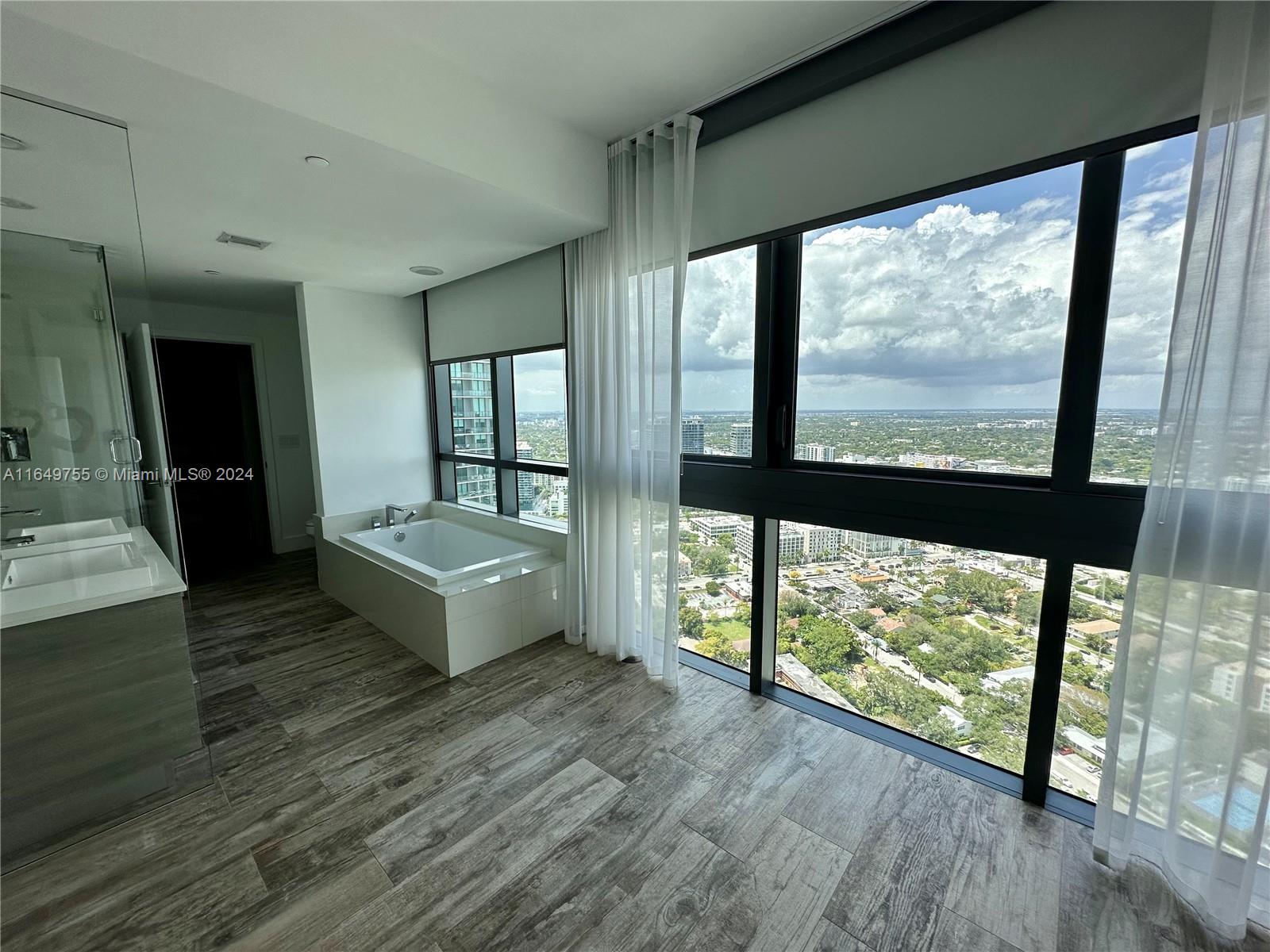 Edgewater Miami, FL 33137 - Photo 5 of 13 a large room with a large window