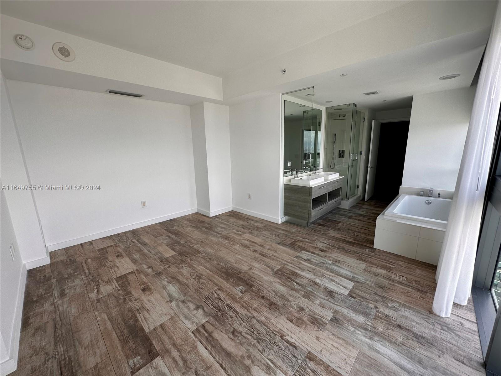 Edgewater Miami, FL 33137 - Photo 6 of 13 a living room with a bed and furniture