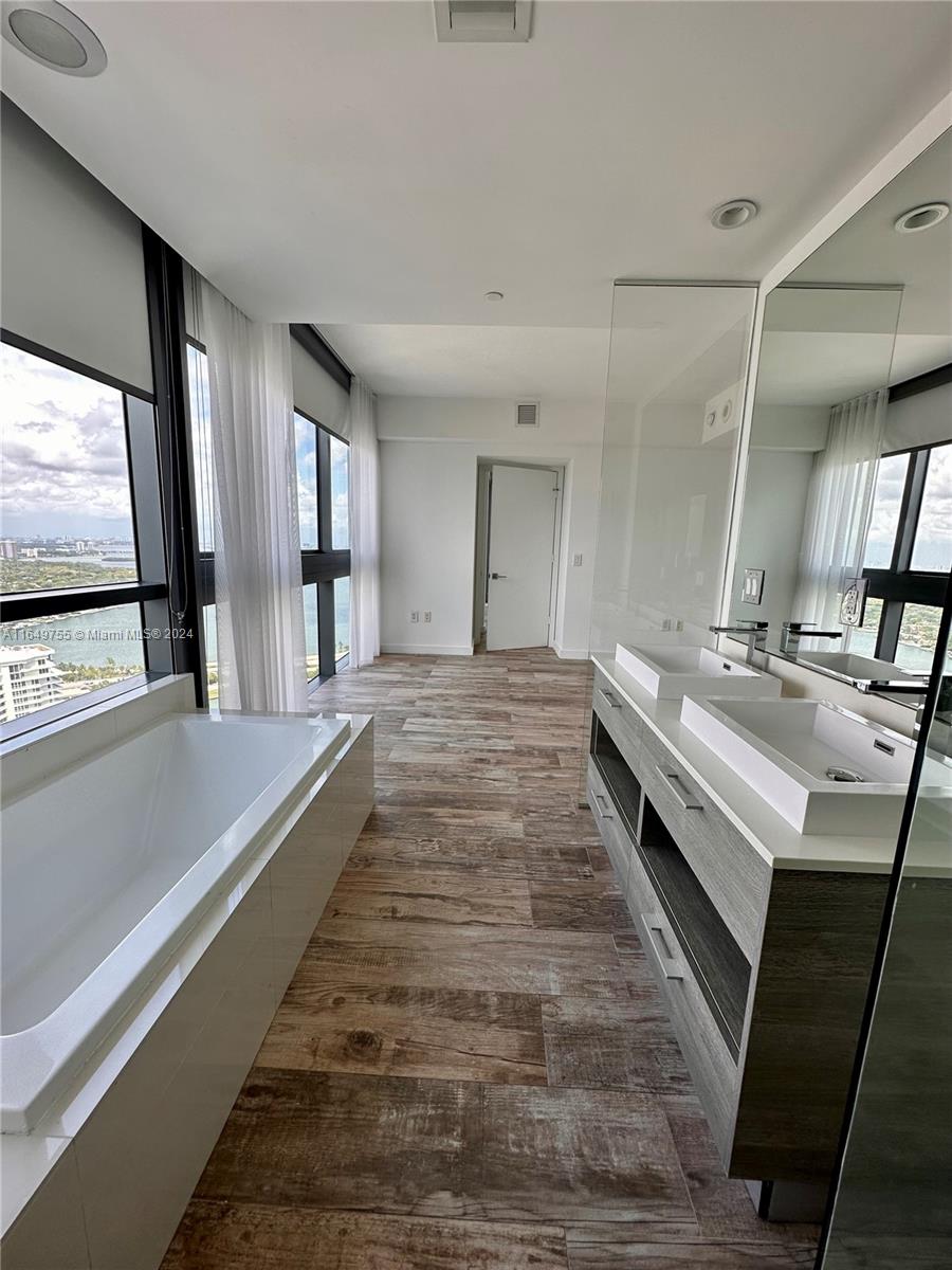 Edgewater Miami, FL 33137 - Photo 9 of 13 a bathroom with a sink and a large mirror