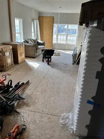 a living room with furniture rug and a window