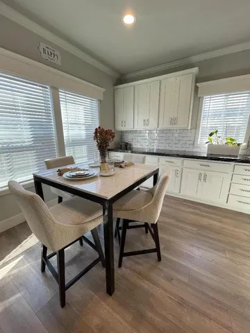 a bathroom with a double vanity sink toilet and shower