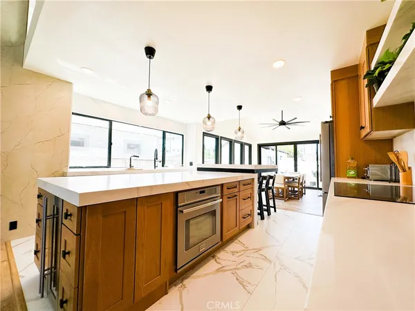a view of living room kitchen island with furniture and wooden floor