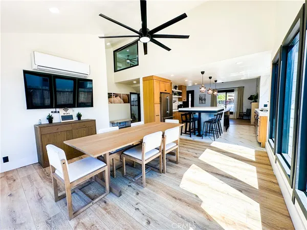 a dining room with a wooden table and chairs