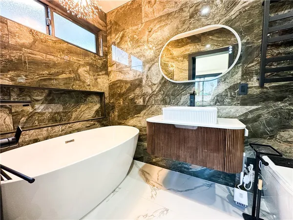 a bathroom with a toilet sink and mirror