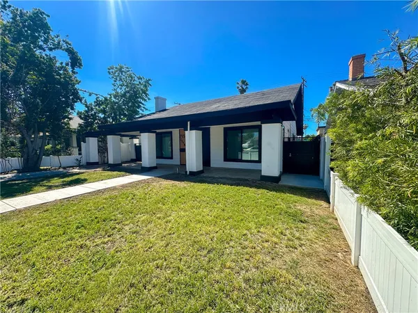 a view of house with backyard and swimming pool