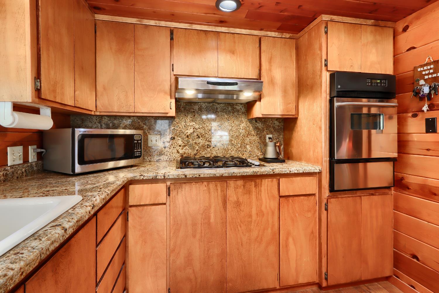 7190 Hites Cove Road Mariposa, CA 95338 - Photo 14 of 61 a kitchen with stainless steel appliances granite countertop a sink a stove and a microwave