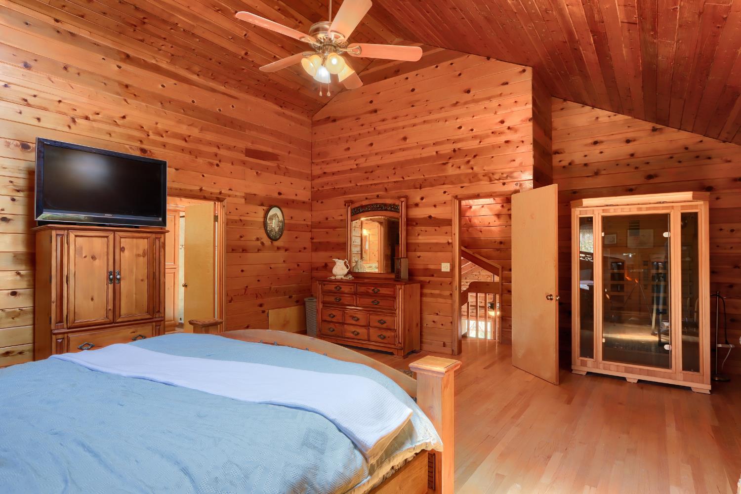 7190 Hites Cove Road Mariposa, CA 95338 - Photo 19 of 61 a bedroom with a bed and a flat screen tv