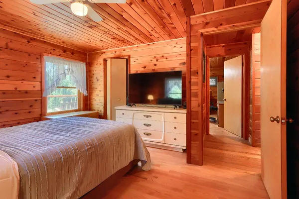 a living room with furniture a rug and wooden floor
