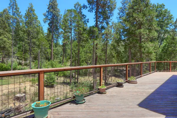 a view of balcony with wooden floor and fence