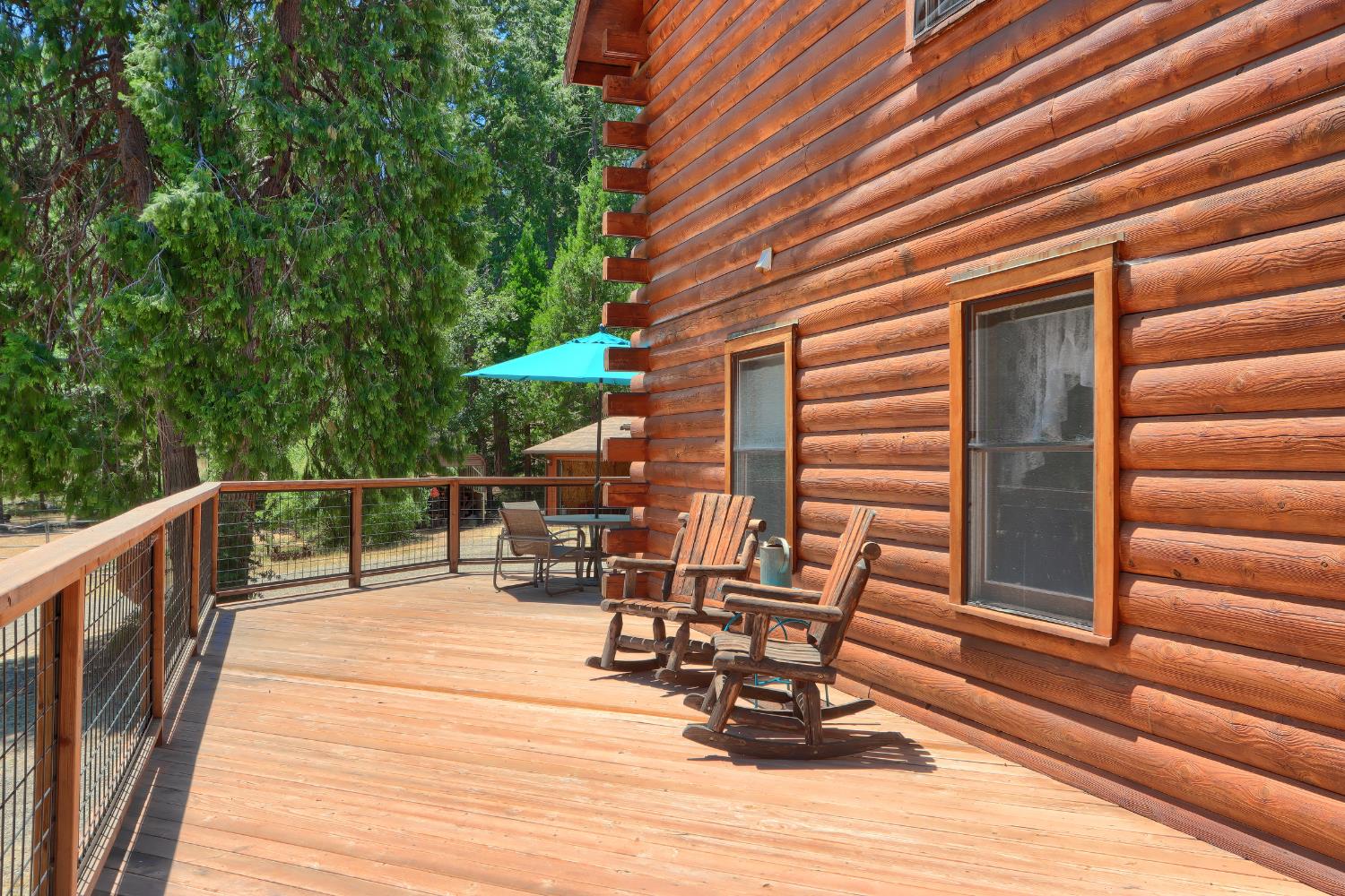 7190 Hites Cove Road Mariposa, CA 95338 - Photo 32 of 61 a view of balcony with chairs and wooden fence