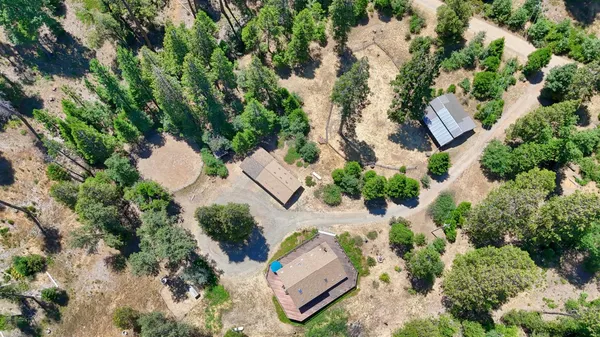 an aerial view of a house with a yard