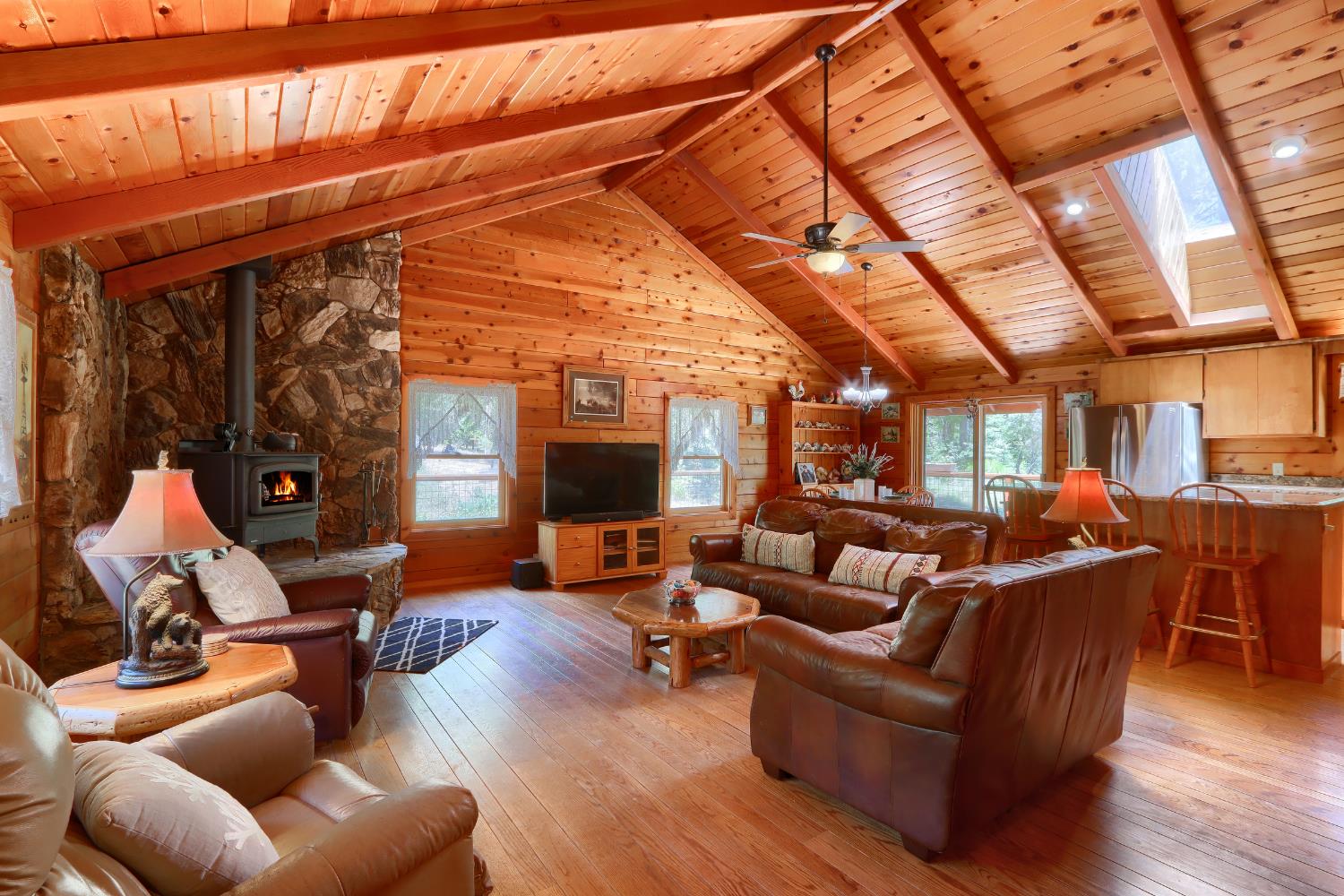 7190 Hites Cove Road Mariposa, CA 95338 - Photo 7 of 61 a living room with furniture a fireplace and wooden floor