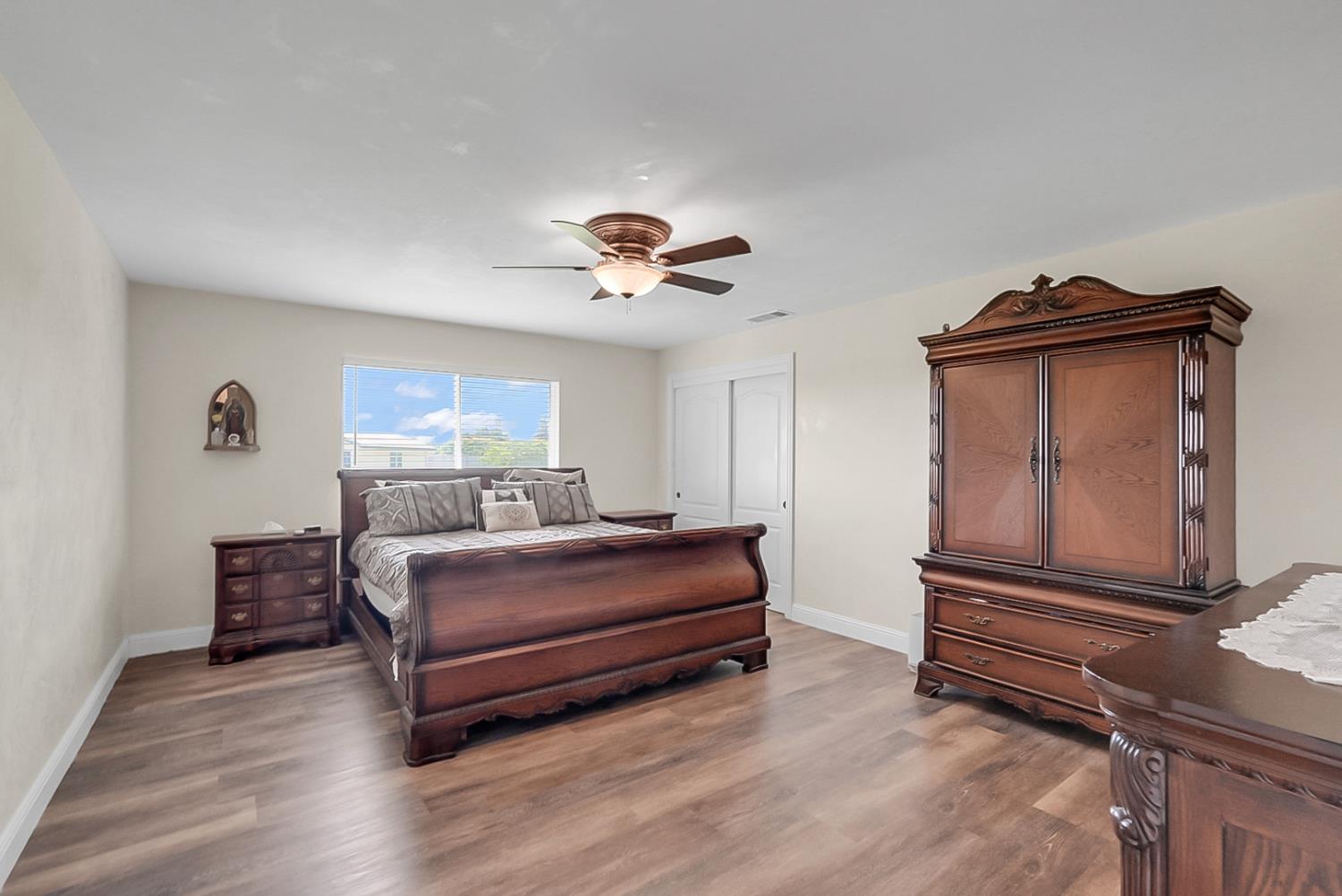 6112 Slaton Court Stockton, CA 95215 - Photo 15 of 46 a living room with a couch and a ceiling fan