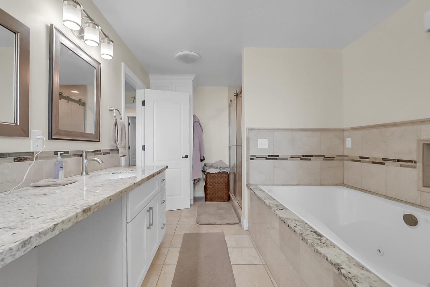 6112 Slaton Court Stockton, CA 95215 - Photo 17 of 46 a spacious bathroom with a tub sink and mirror
