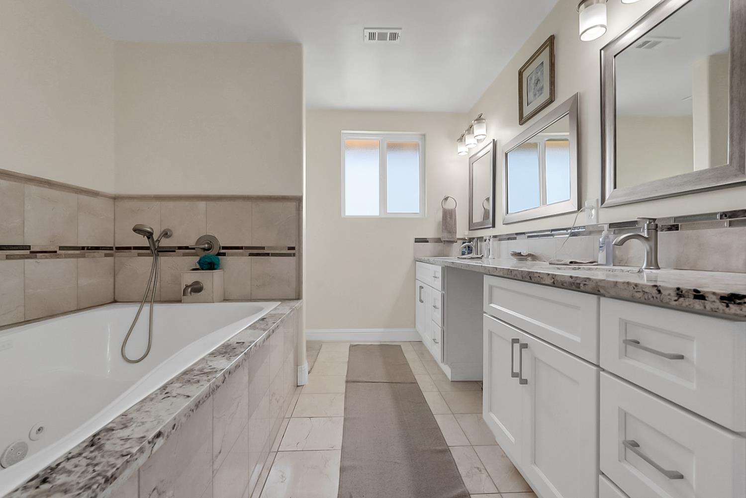 6112 Slaton Court Stockton, CA 95215 - Photo 18 of 46 a bathroom with a tub a sink and a mirror