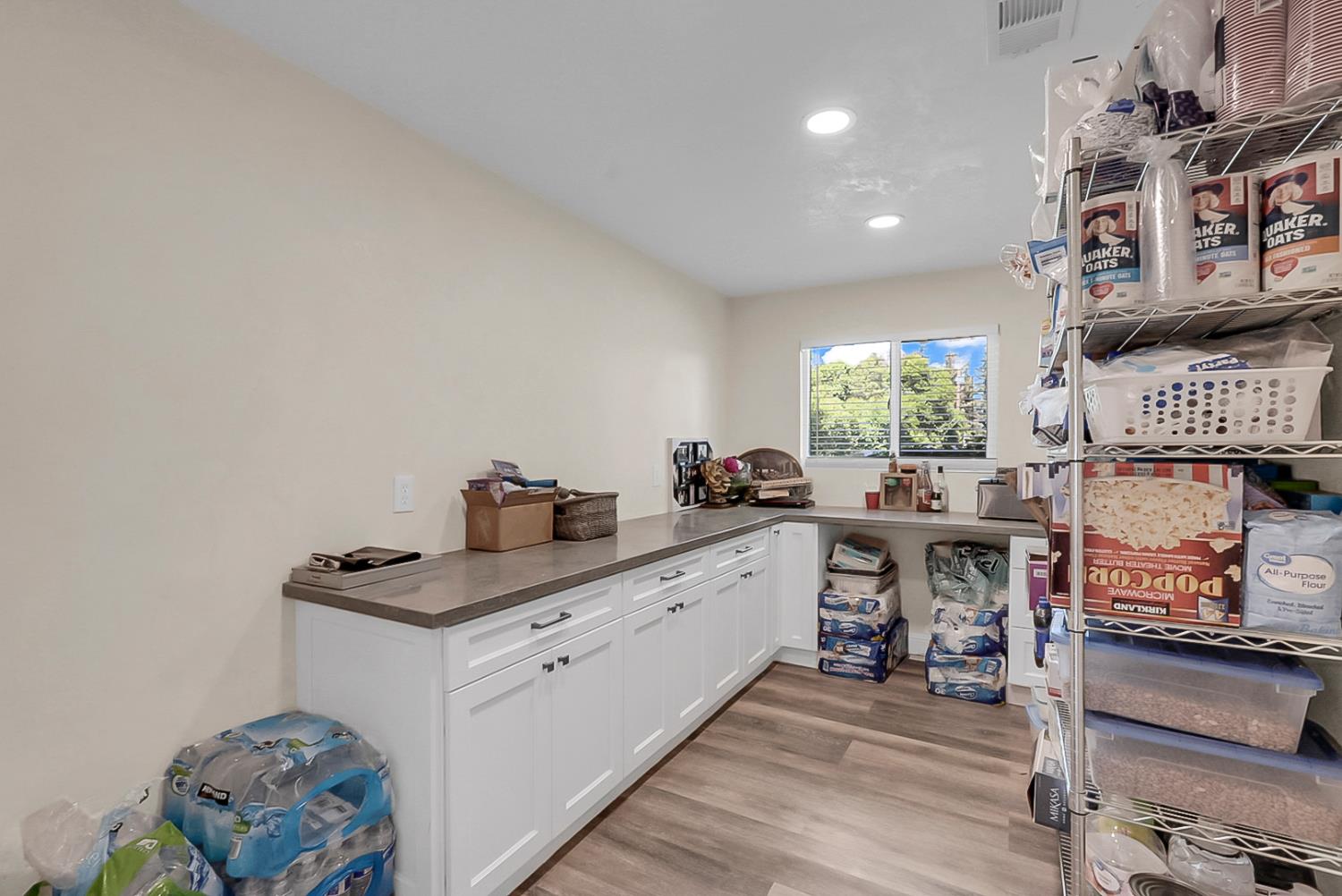 6112 Slaton Court Stockton, CA 95215 - Photo 23 of 46 a kitchen with granite countertop a sink cabinets and window