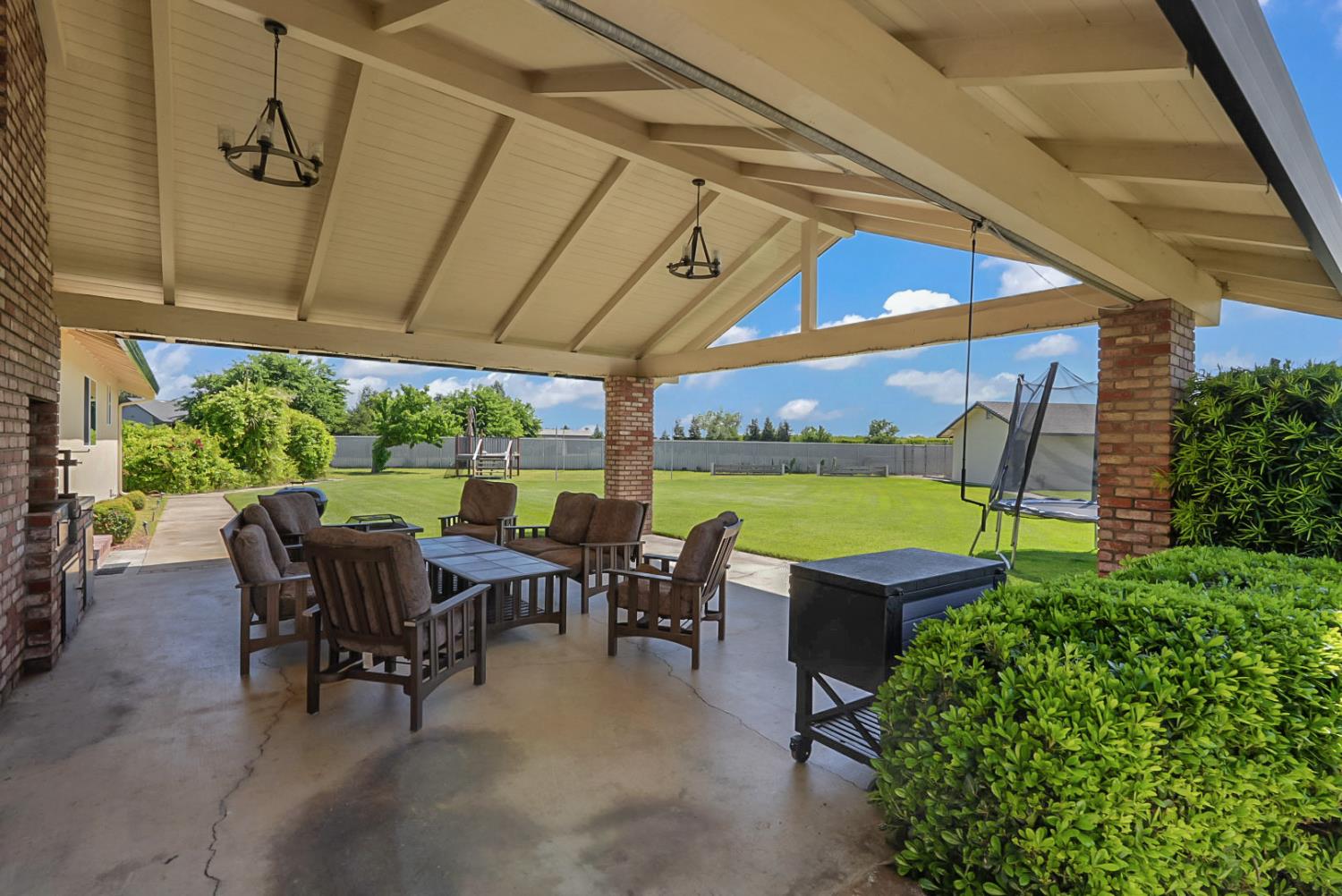 6112 Slaton Court Stockton, CA 95215 - Photo 28 of 46 a view of a patio with table and chairs potted plants and floor to ceiling window