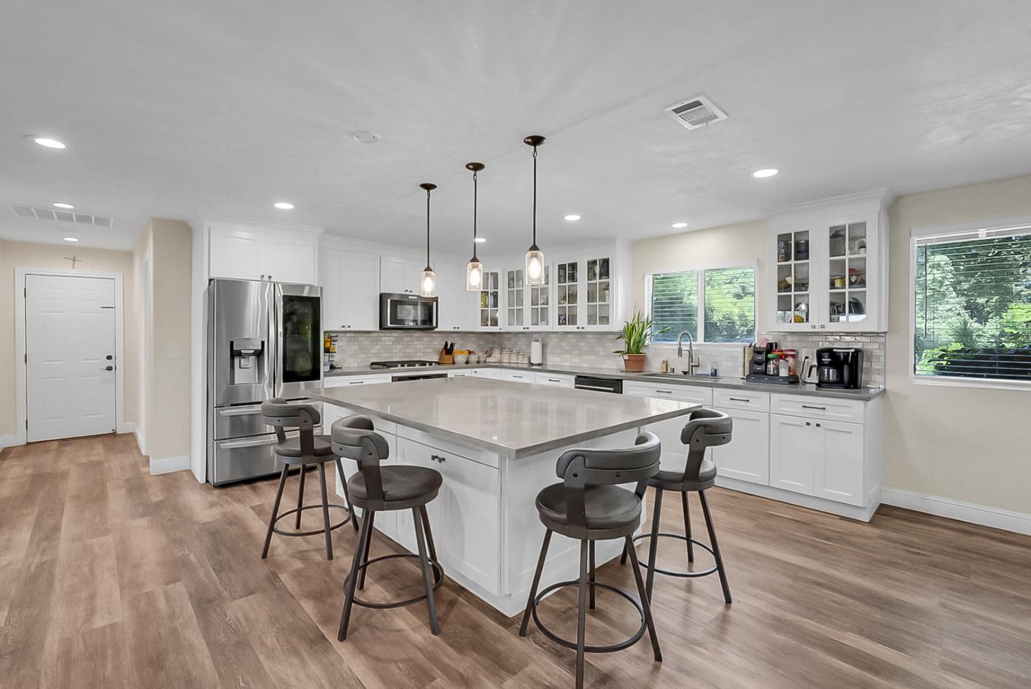 6112 Slaton Court Stockton, CA 95215 - Photo 9 of 46 a kitchen with stainless steel appliances kitchen island granite countertop a table chairs and a refrigerator