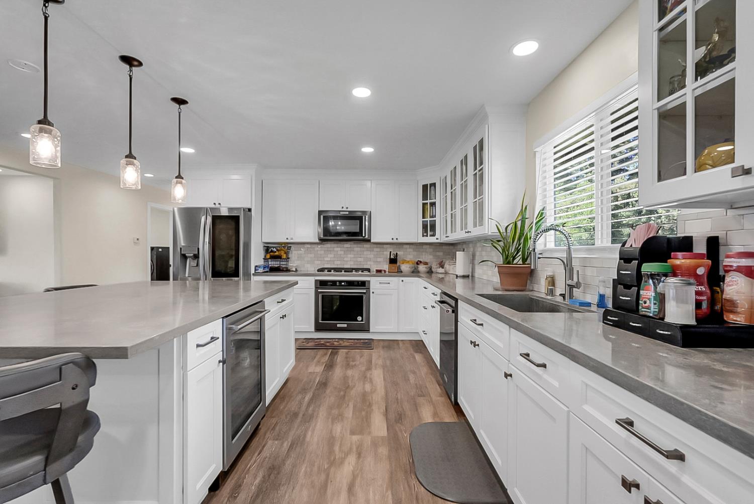 6112 Slaton Court Stockton, CA 95215 - Photo 10 of 46 a large kitchen with stainless steel appliances granite countertop a sink a stove and cabinets