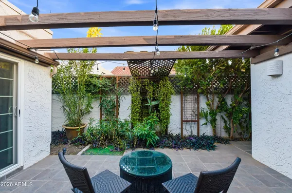 a front view of a house with a yard and potted plants