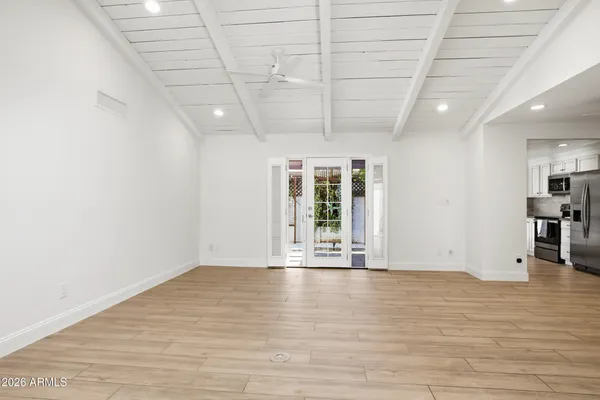 a view of an empty room with wooden floor