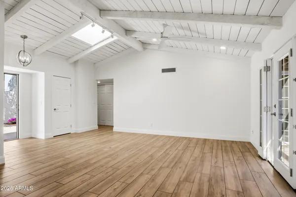 a view of a room with wooden floor