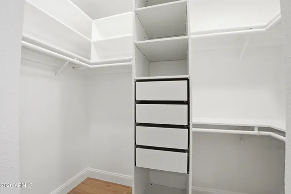 a view of walk in closet with empty racks