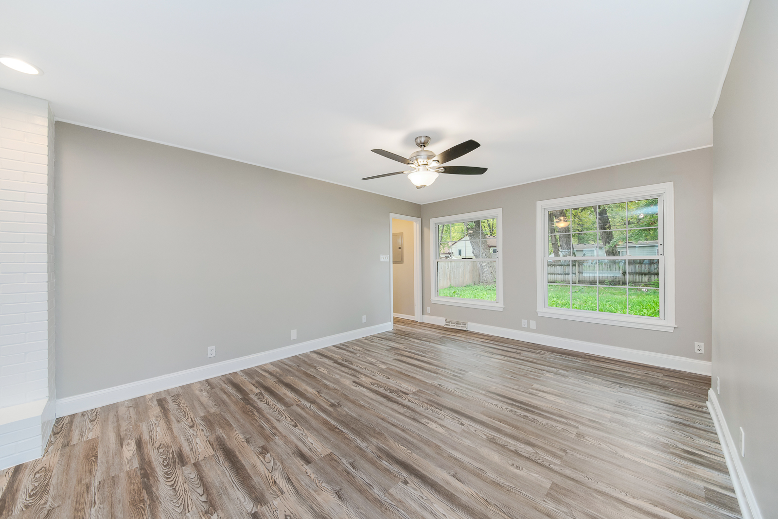 24 Greenbriar Road Montgomery, IL 60538 - Photo 3 of 16 a view of an empty room with a window and wooden floor