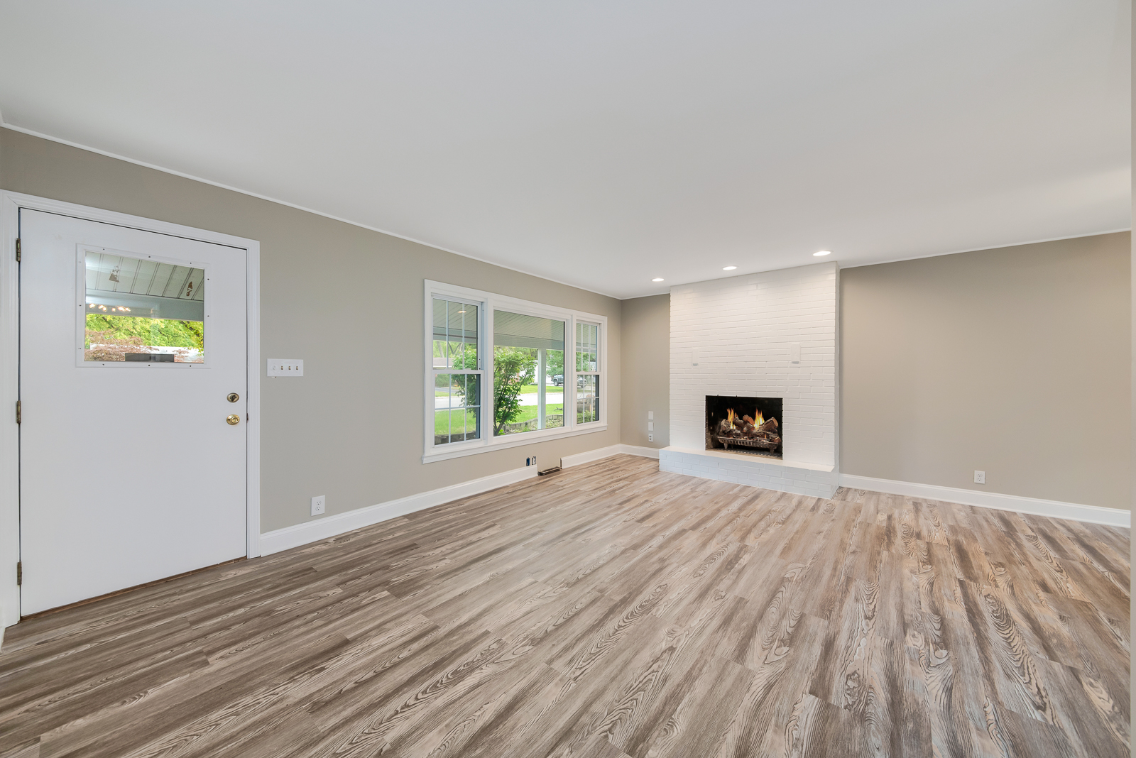 24 Greenbriar Road Montgomery, IL 60538 - Photo 4 of 16 an empty room with windows and fireplace