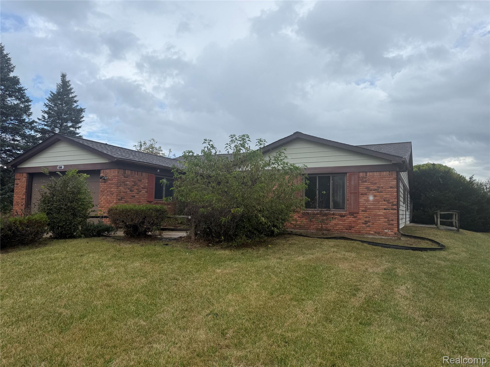 15505 Hoeft Road Belleville, MI 48111 - Photo 1 of 21 View of front of house featuring brick siding and a front yard
