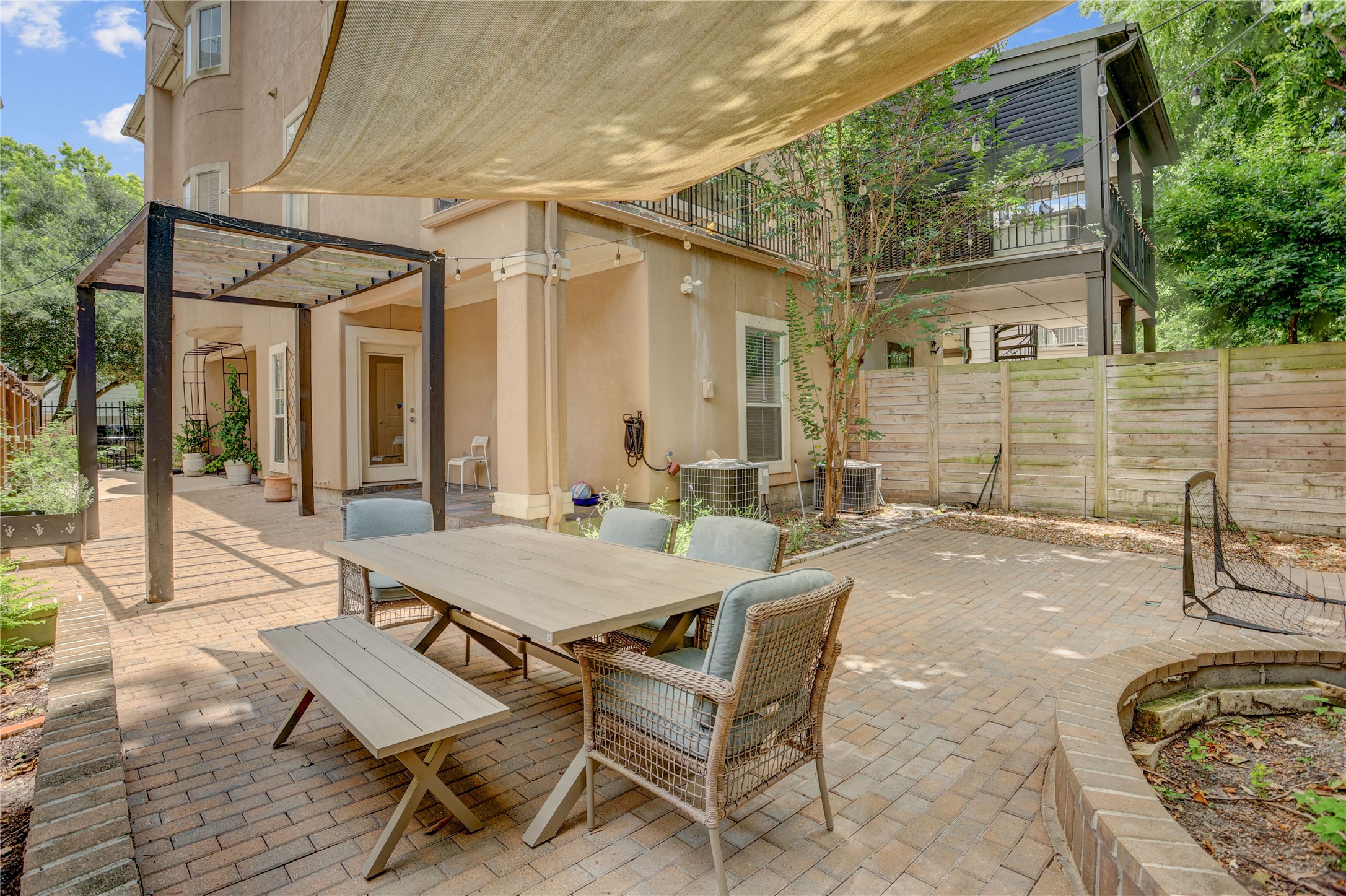 4262 Childress Street, Unit B Houston, TX 77005 - Photo 22 of 22 a view of a patio with table and chairs and potted plants