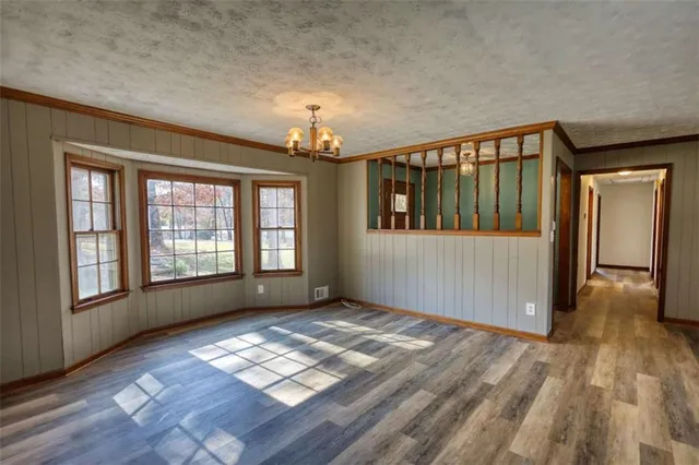 a kitchen with stainless steel appliances a stove a sink and a refrigerator with wooden floor