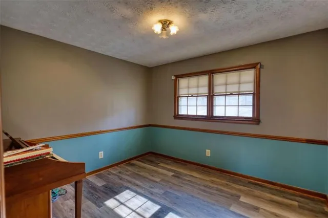 a bedroom with a large bed a chandelier and windows