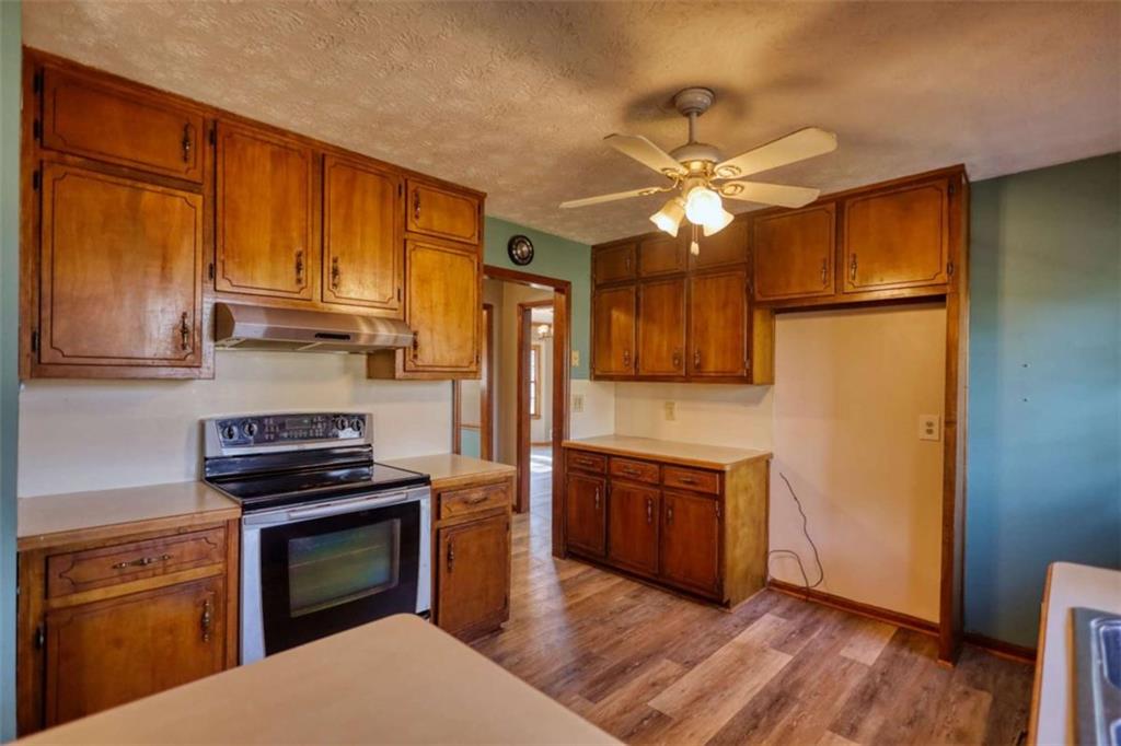 2289 Amberbrook Drive Southwest Conyers, GA 30094 - Photo 22 of 79 a kitchen with stainless steel appliances granite countertop a refrigerator a stove and a sink with wooden floor