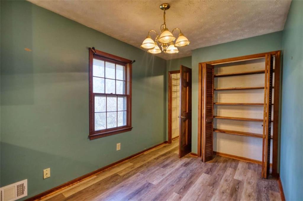 2289 Amberbrook Drive Southwest Conyers, GA 30094 - Photo 23 of 79 a view of an empty room with a window and wooden floor