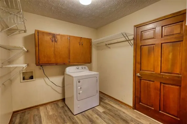 an empty room with windows closet and chandelier fan