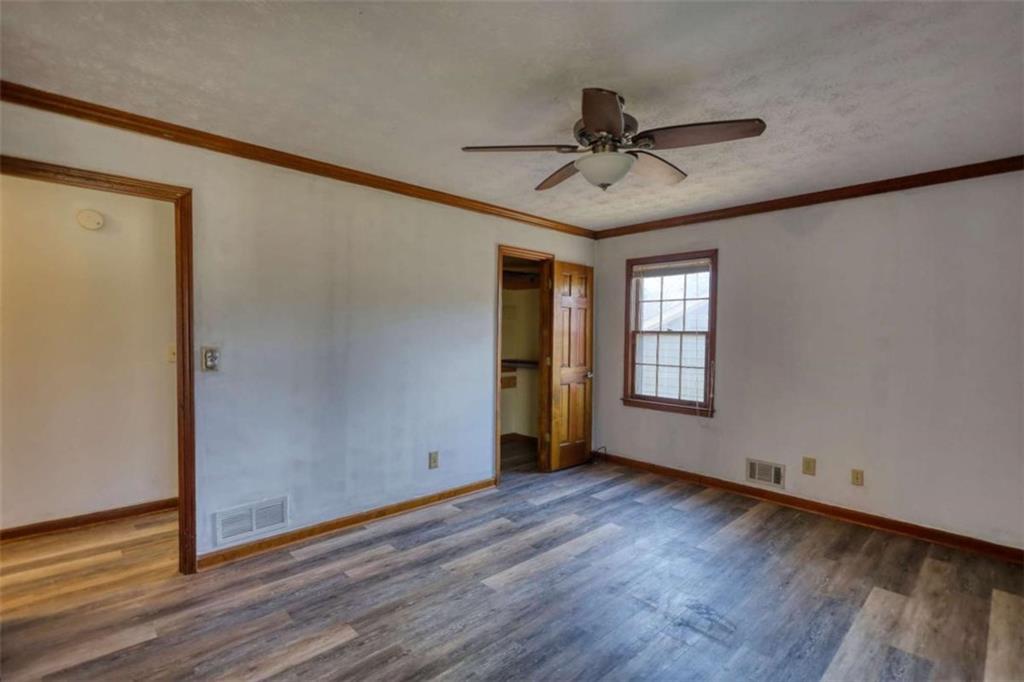 2289 Amberbrook Drive Southwest Conyers, GA 30094 - Photo 28 of 79 a view of an empty room with wooden floor and a window