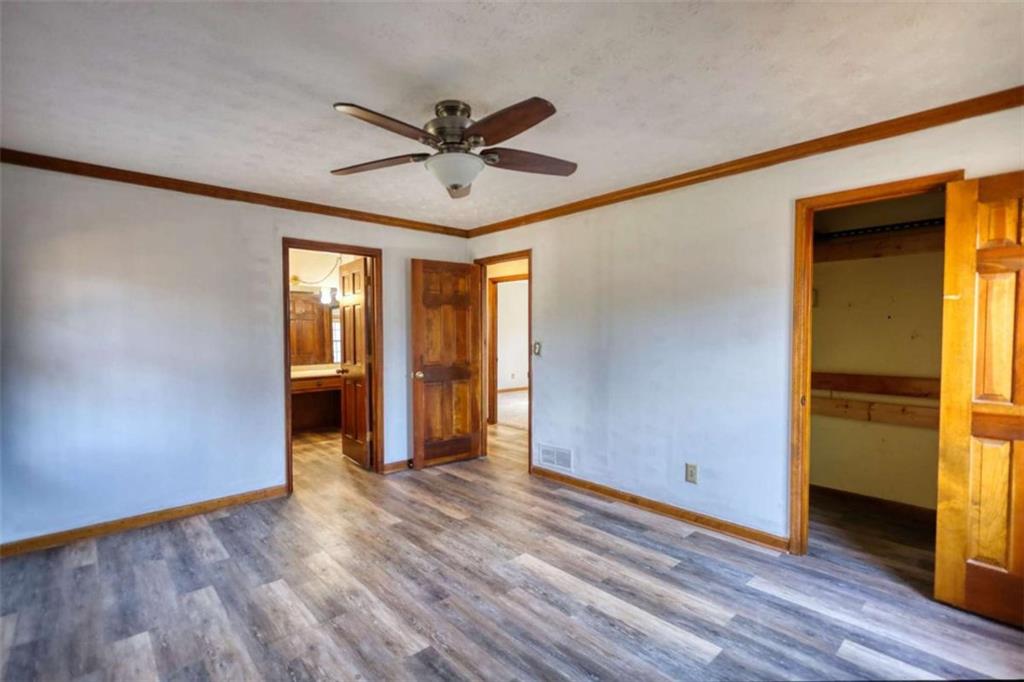 2289 Amberbrook Drive Southwest Conyers, GA 30094 - Photo 29 of 79 a view of empty room with wooden floor and fan