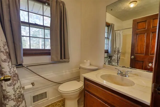 a kitchen with stainless steel appliances granite countertop a refrigerator a stove and a sink