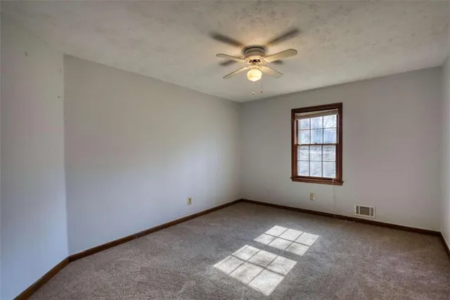 a view of a room with wooden floor and a window