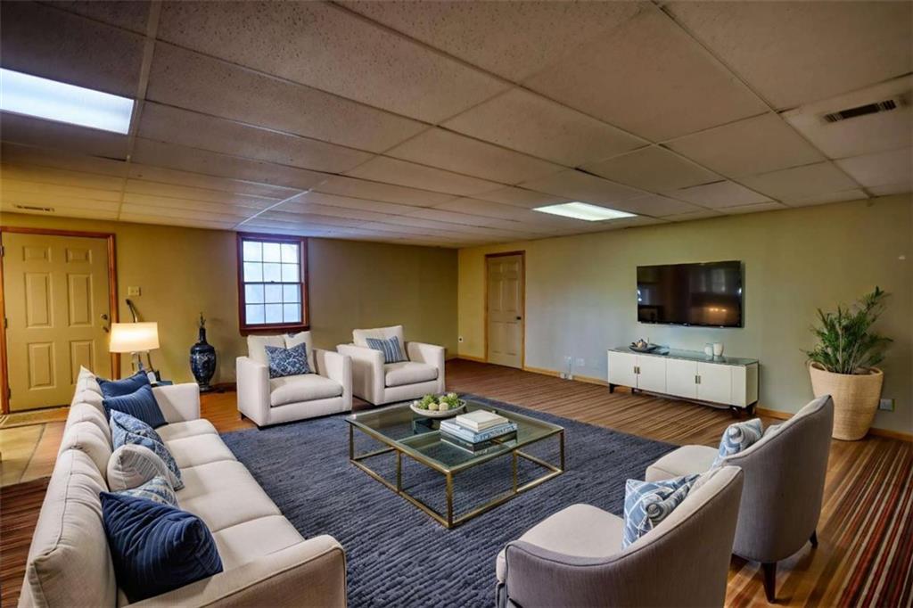 2289 Amberbrook Drive Southwest Conyers, GA 30094 - Photo 44 of 79 a living room with furniture and a flat screen tv