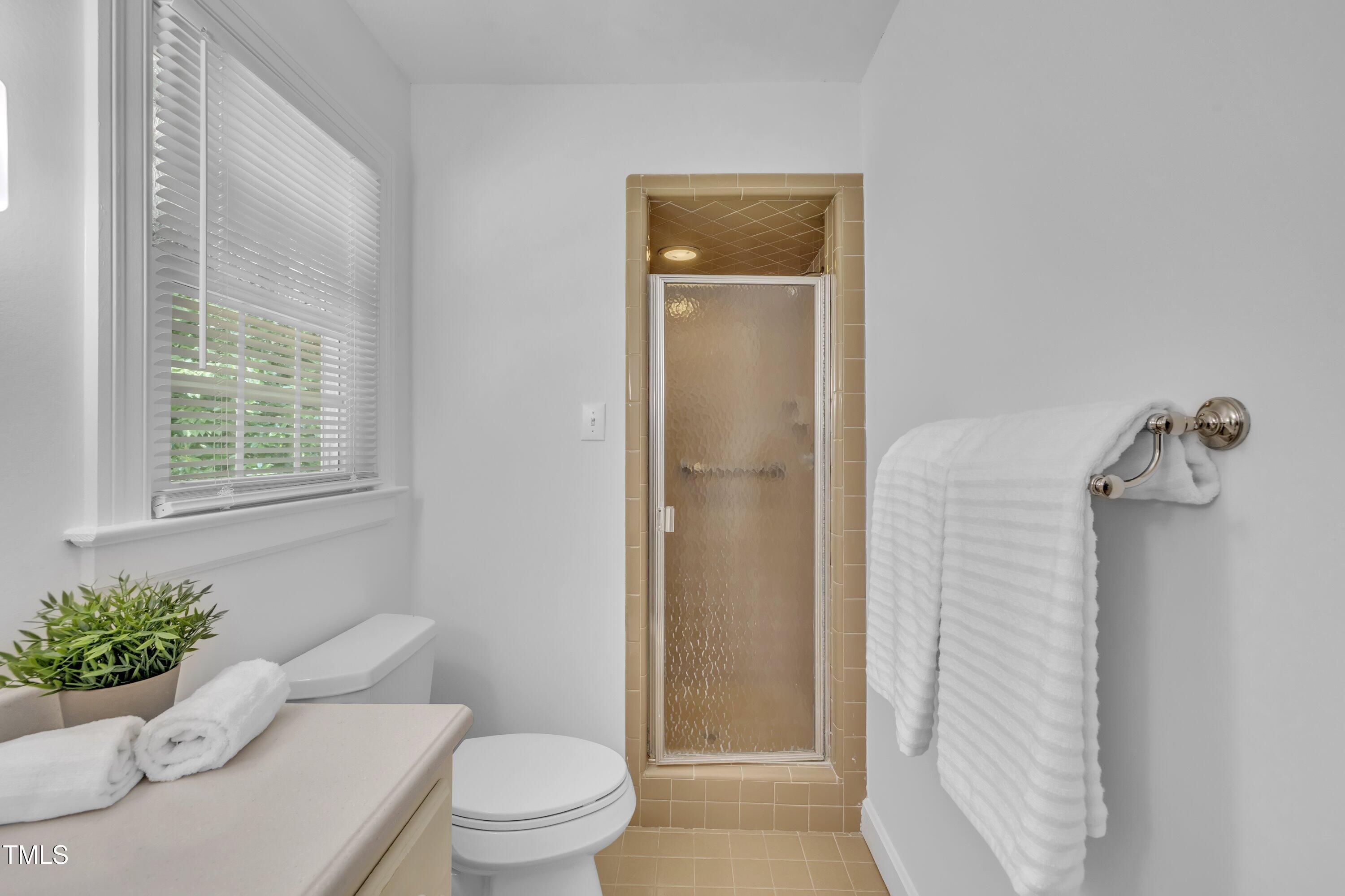 2204 Basil Drive Raleigh, NC 27612 - Photo 26 of 49 a white toilet sitting next to a bathroom sink and tub