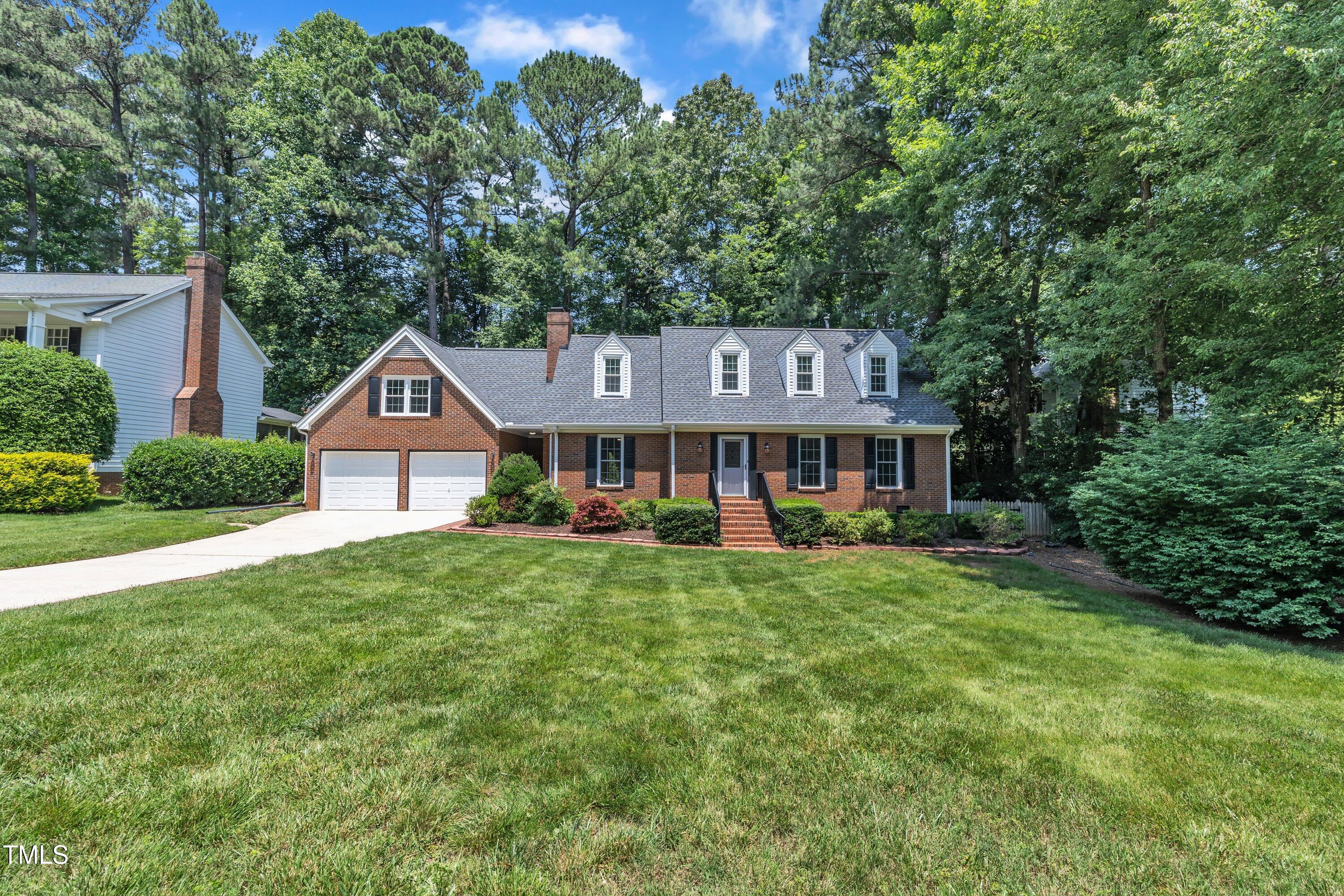 2204 Basil Drive Raleigh, NC 27612 - Photo 46 of 49 a front view of a house with yard and green space